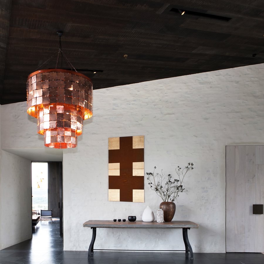 Entry hall with the same dark timber ceiling and a limewashed timber door