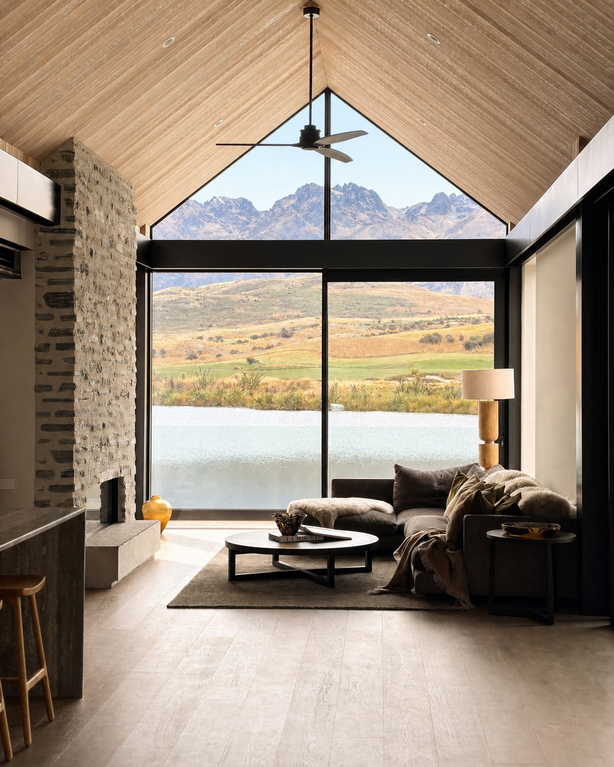 Living room at Lake Tewa with a timber-lined gable ceiling, pale oak floors and a view to the Remarkables