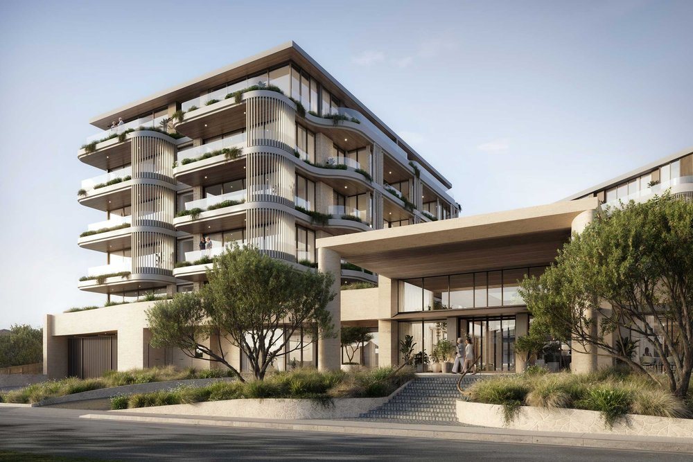 The Pitau from the street: a curved, terraced residential tower above a covered entrance and landscaped steps