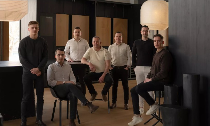 The Kindred Timber team, five brothers and family, in a showroom lined with timber samples